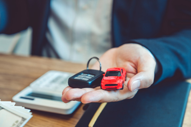 sale agent giving car key