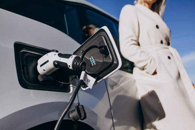 woman charging electro car